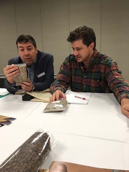 Mario Fernandez and Joel Schuler look at the coffee samples from the Philippines. They knew what was missing.